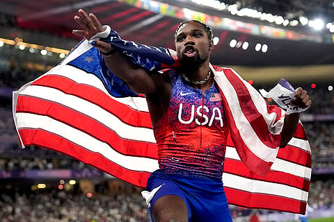 Noah Lyles celebrates after winning gold in the men's 100-meters final 
